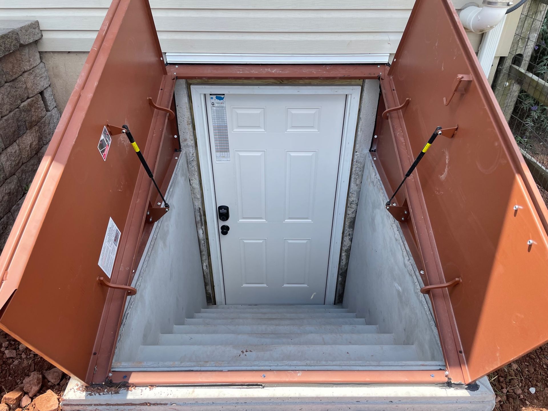 A basement door with stairs leading up to it.