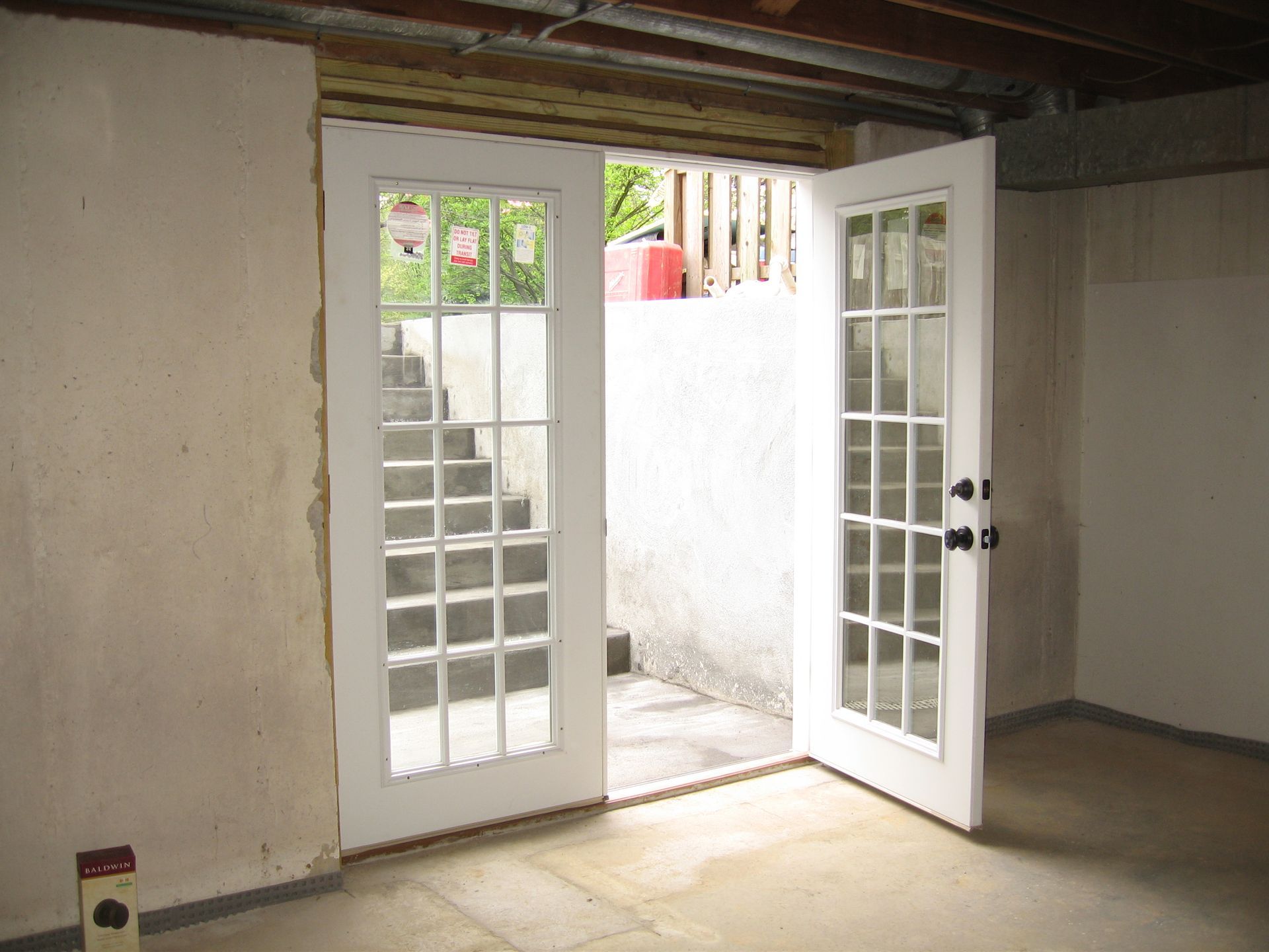 An empty room with a french door that is open