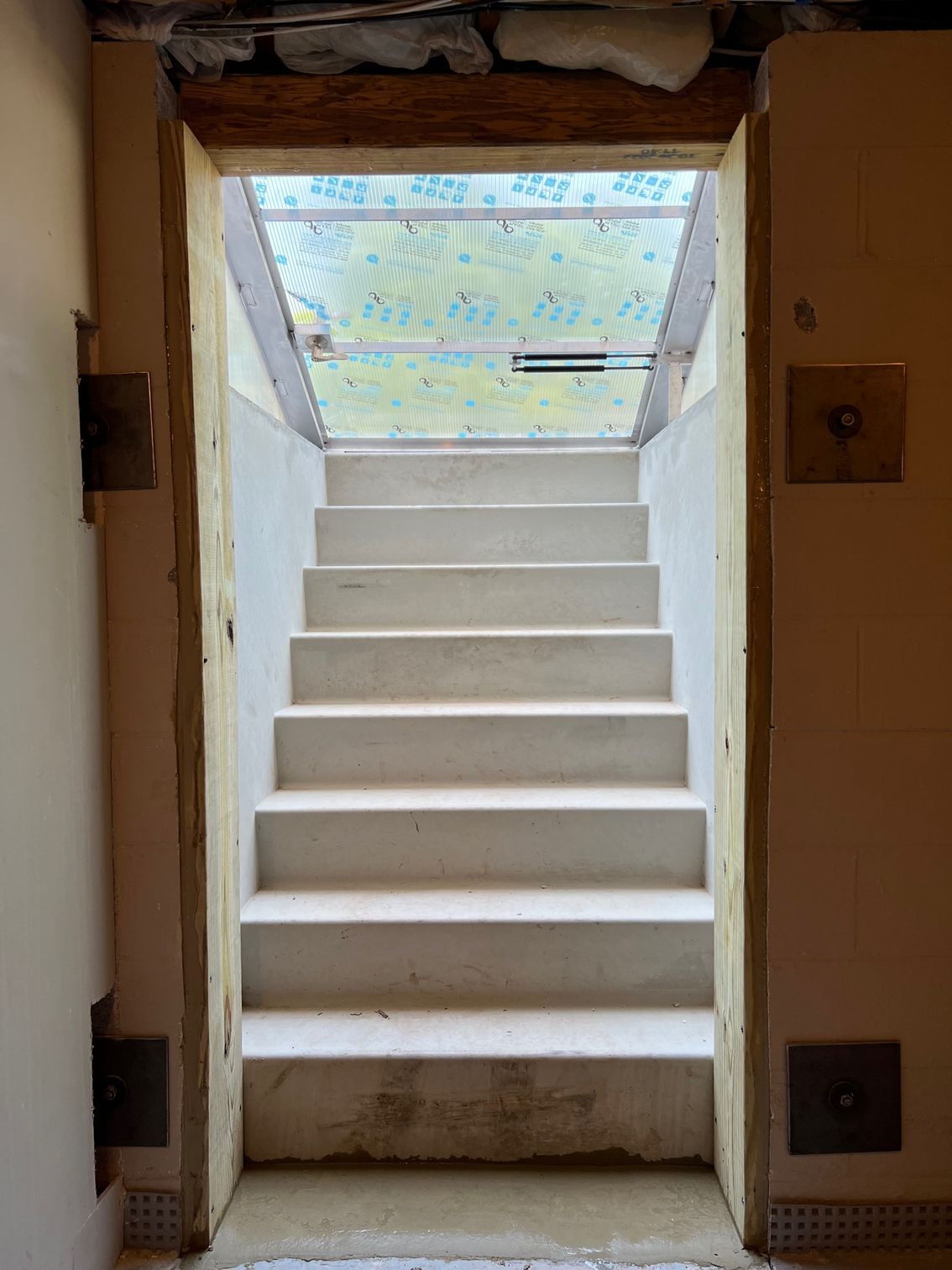 A cross is drawn in the grass in front of a house.