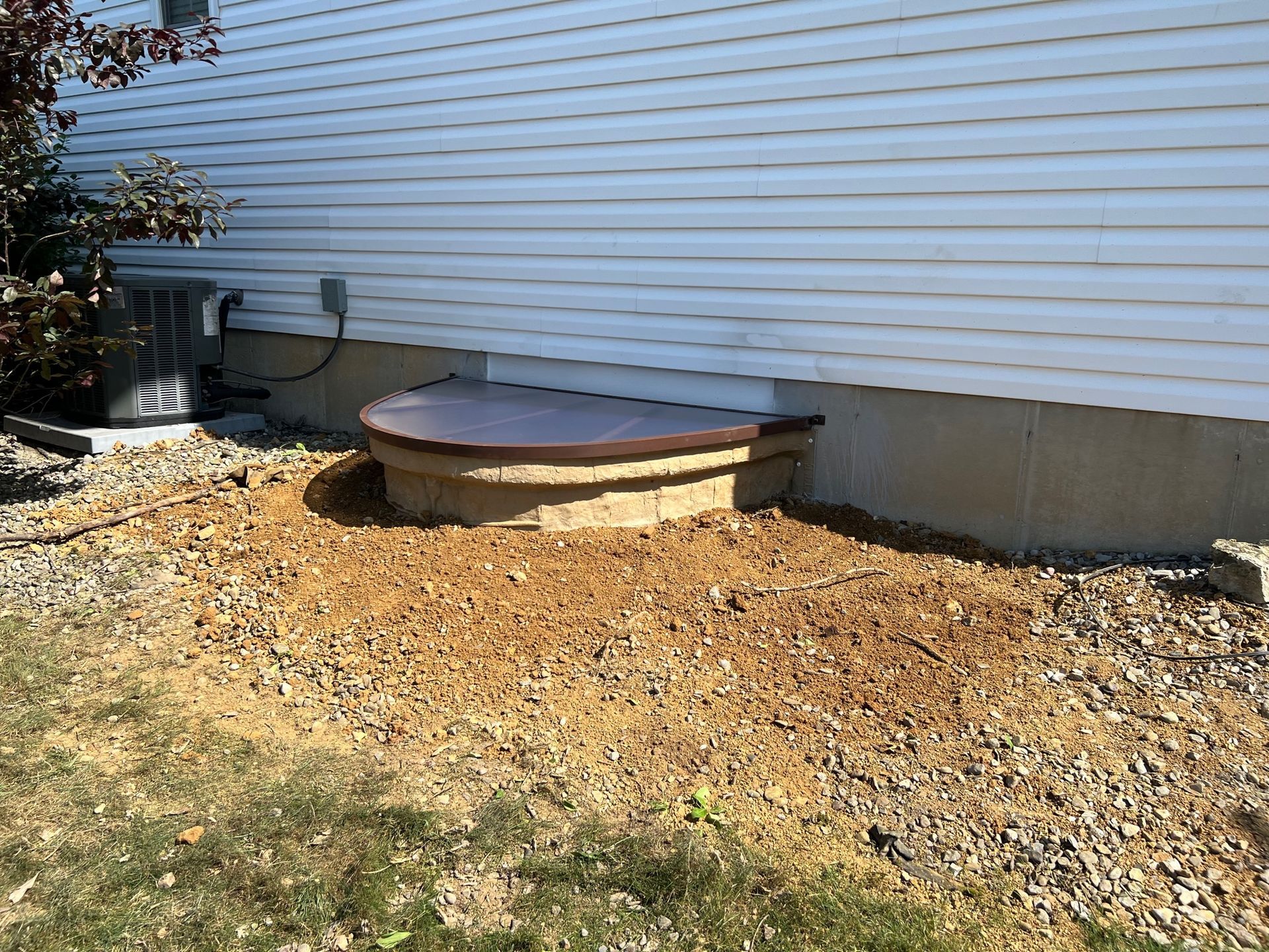 A white house with a well in the backyard.