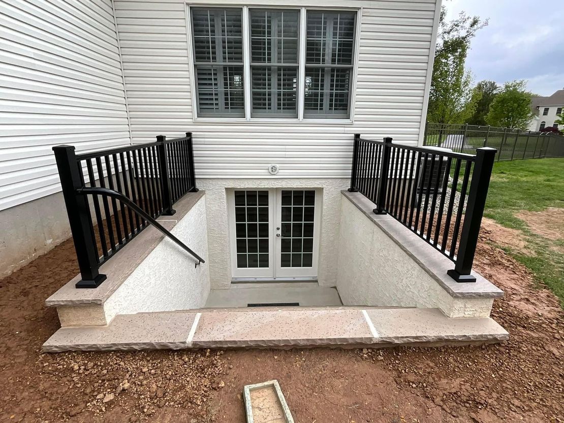 A basement with stairs leading up to it and a window.