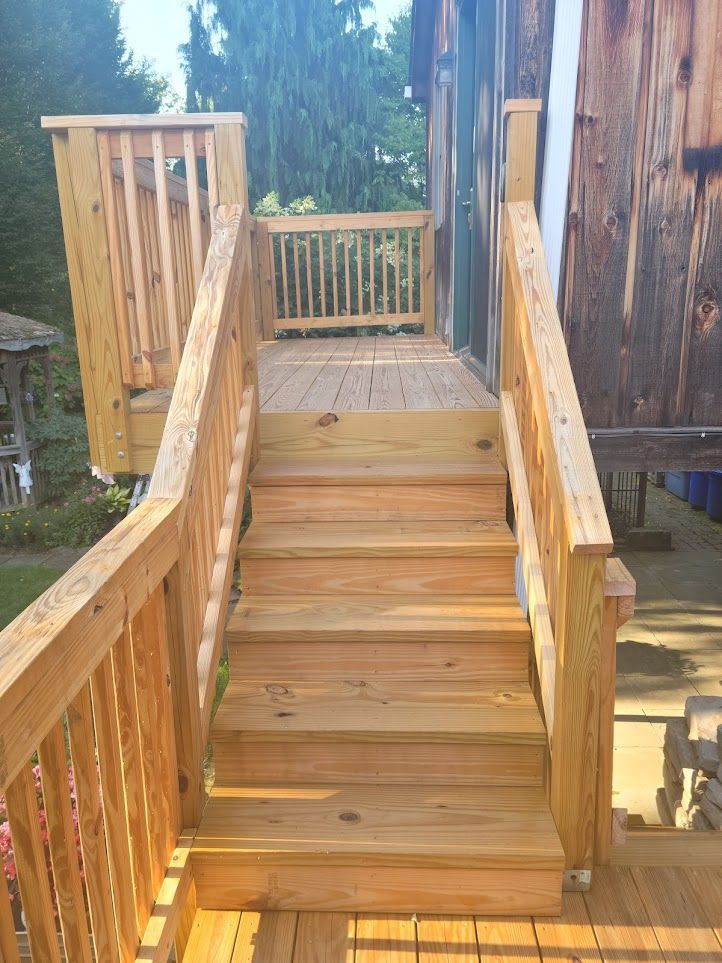 A wooden deck with stairs leading up to it.