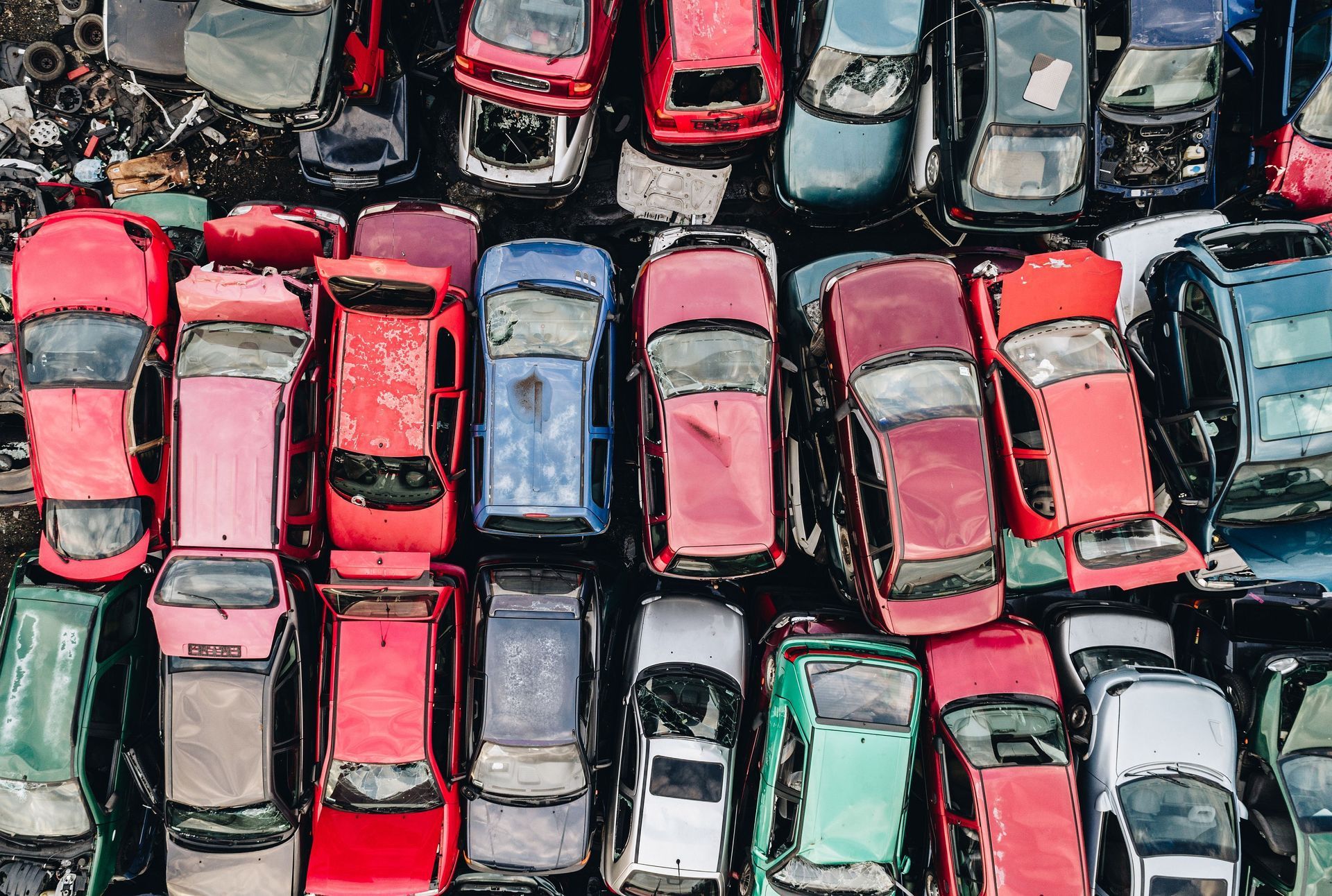 A bunch of cars are parked next to each other in a parking lot.