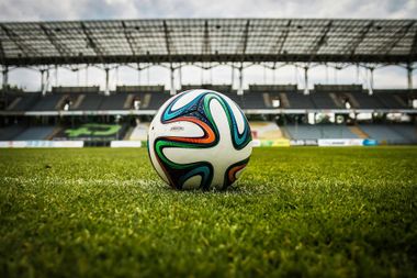 Soccer ball on green field in a stadium