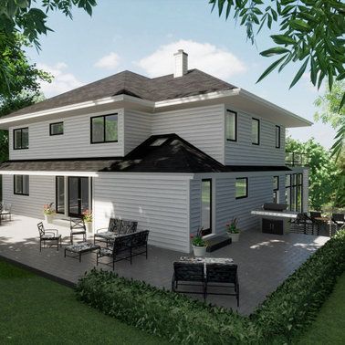 A white house with a black roof and a large patio area.