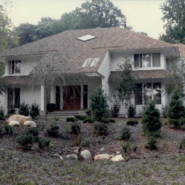 A large white house with a brown roof