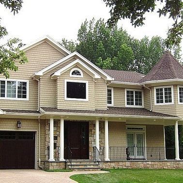 A large house with a porch and a garage