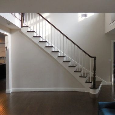 A staircase with a white railing and wooden steps
