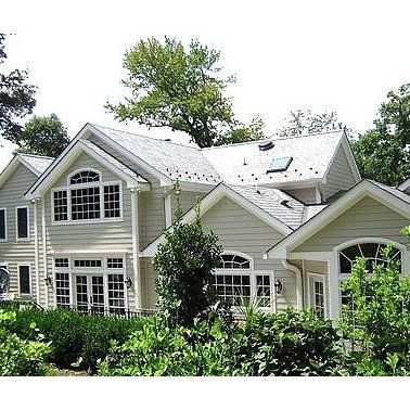 A large house with a lot of windows and a skylight on the roof