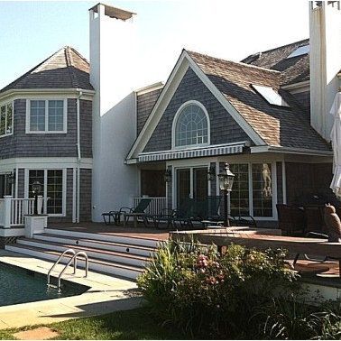 A large house with a swimming pool in front of it