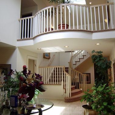 A staircase with a curved railing in a house
