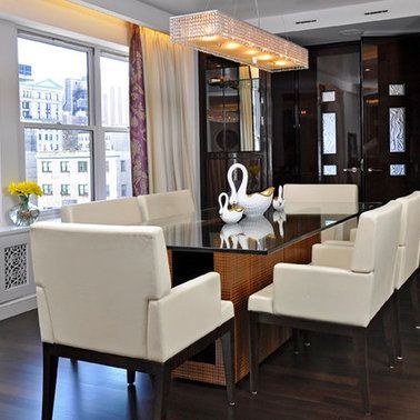 A dining room with a glass table and chairs