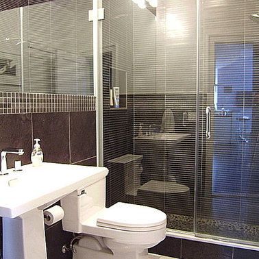 A bathroom with a toilet , sink , and shower.