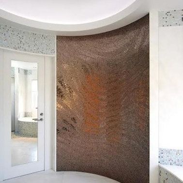 A bathroom with a curved wall and a door with a mirror.