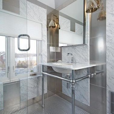 A bathroom with a sink , mirror , and window.