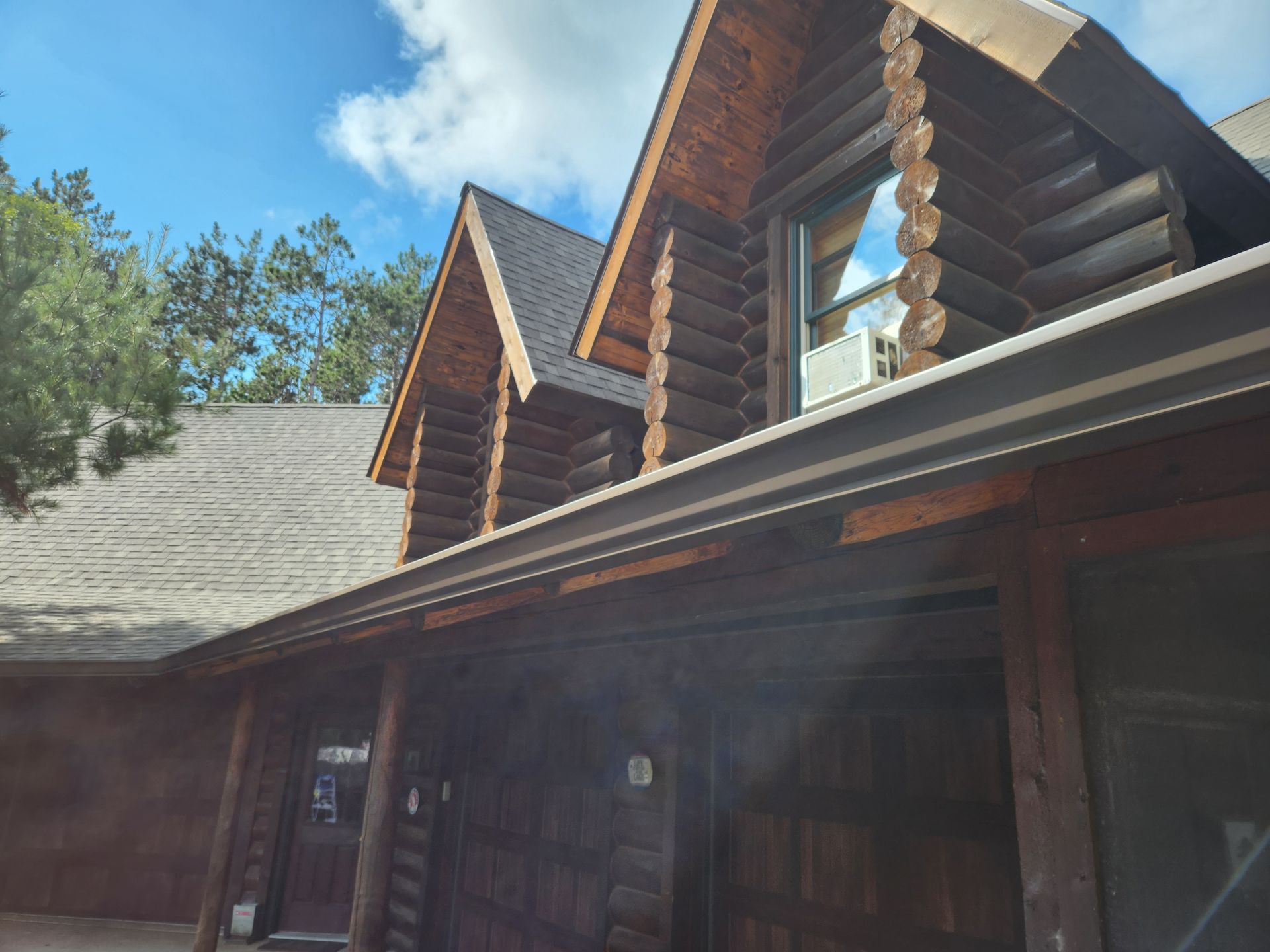 A log cabin with a roof that has a gutter on it
