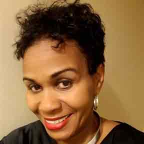 A woman with short hair and red lipstick is smiling for the camera.