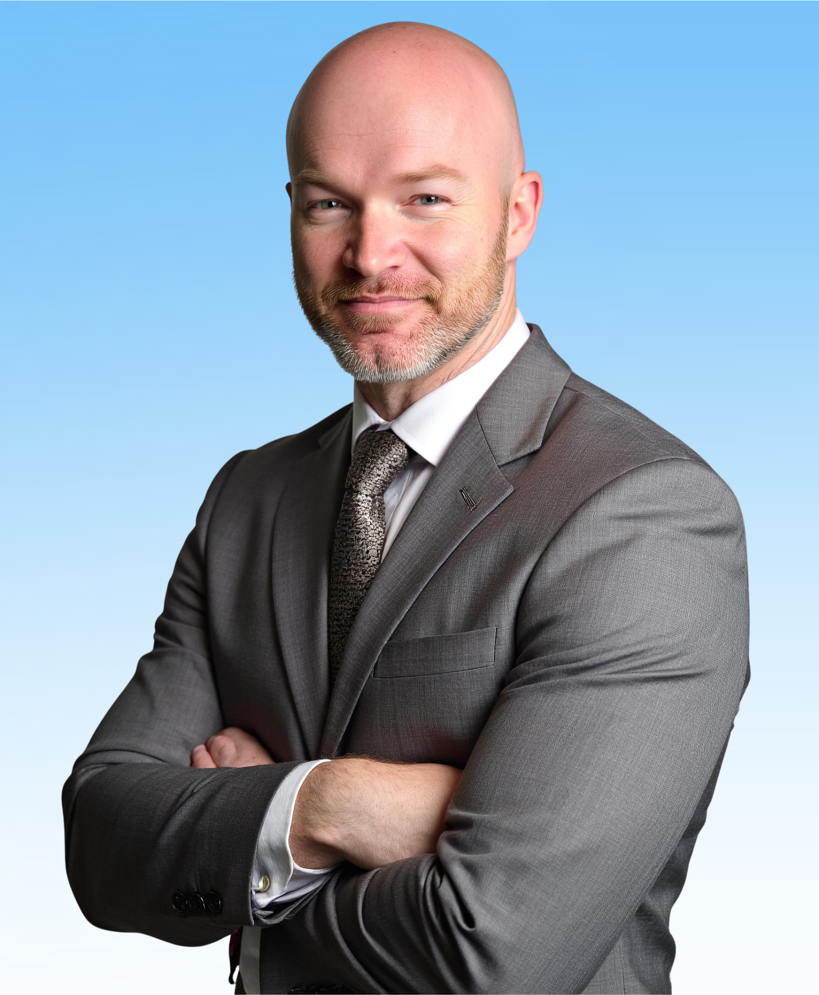 Man in gray suit with arms crossed, smiling against a blue gradient backdrop.