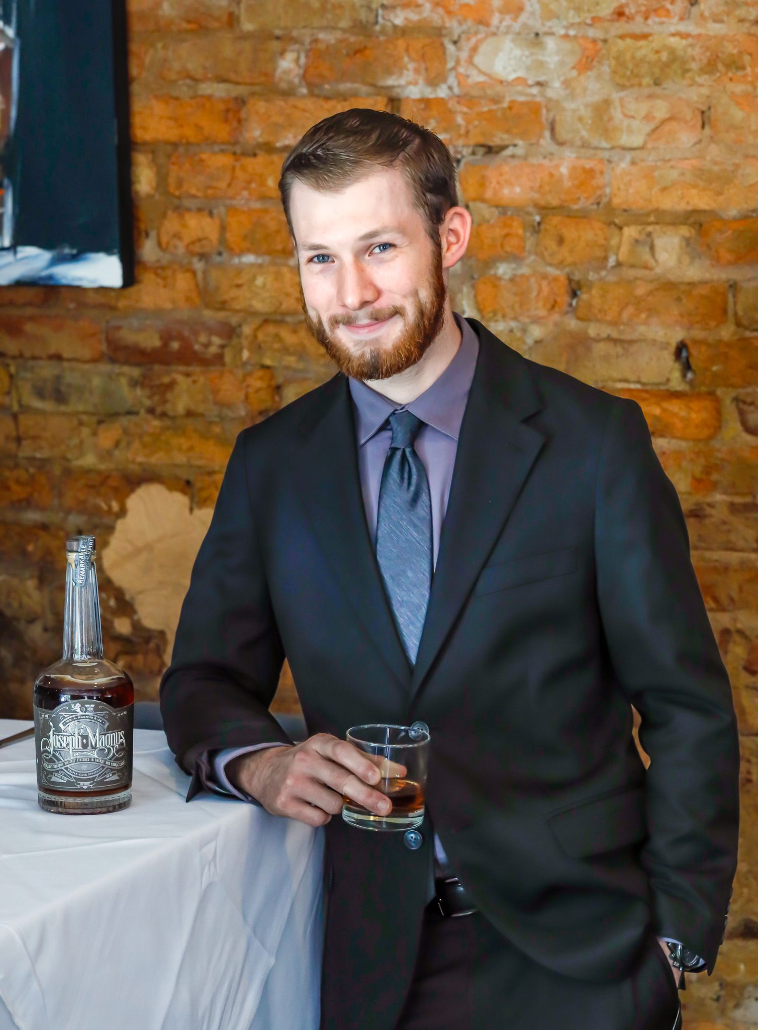 A woman is sitting at a table holding a plate of food.