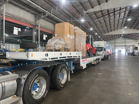 Truck Loaded With Boxes and a Forklift Inside a Warehouse — Supertilt Brisbane In Bracken Ridge, QLD