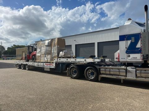 Semi-truck With a Flatbed Trailer Transporting Large, Wrapped Packages — Supertilt Brisbane In Bracken Ridge, QLD