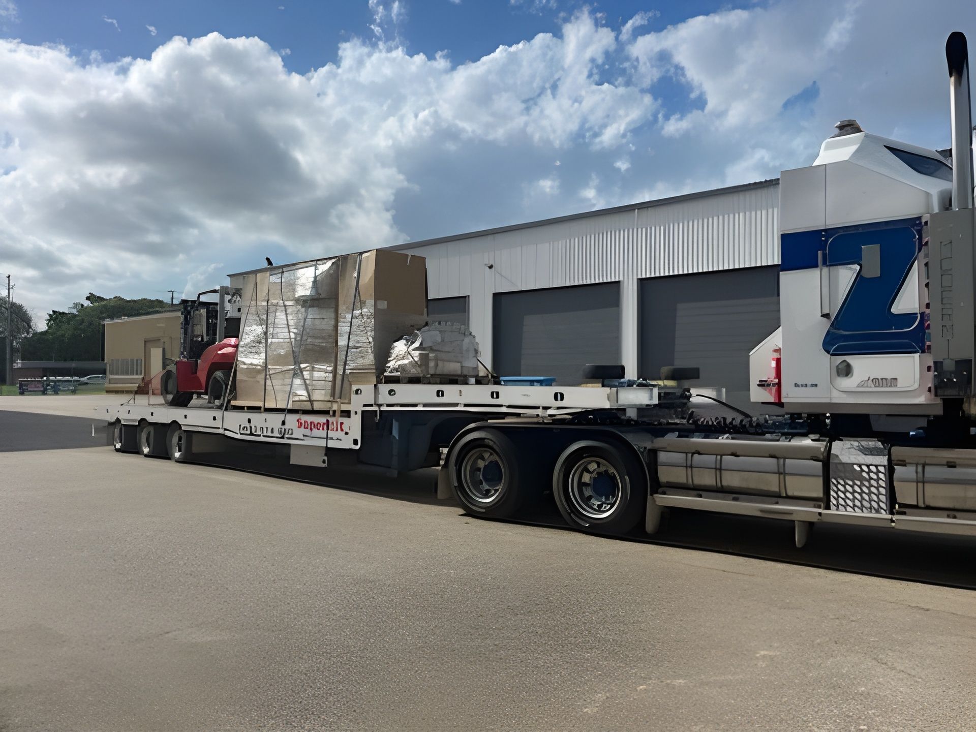 Truck Hauling Large Packaged Items on a Flatbed Trailer — Supertilt Brisbane In Brendale, QLD