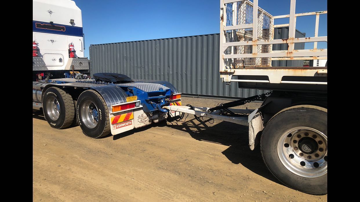 Truck Pulling a Container and a Trailer on a Dirt Road — Supertilt Brisbane In Staplyton, QLD