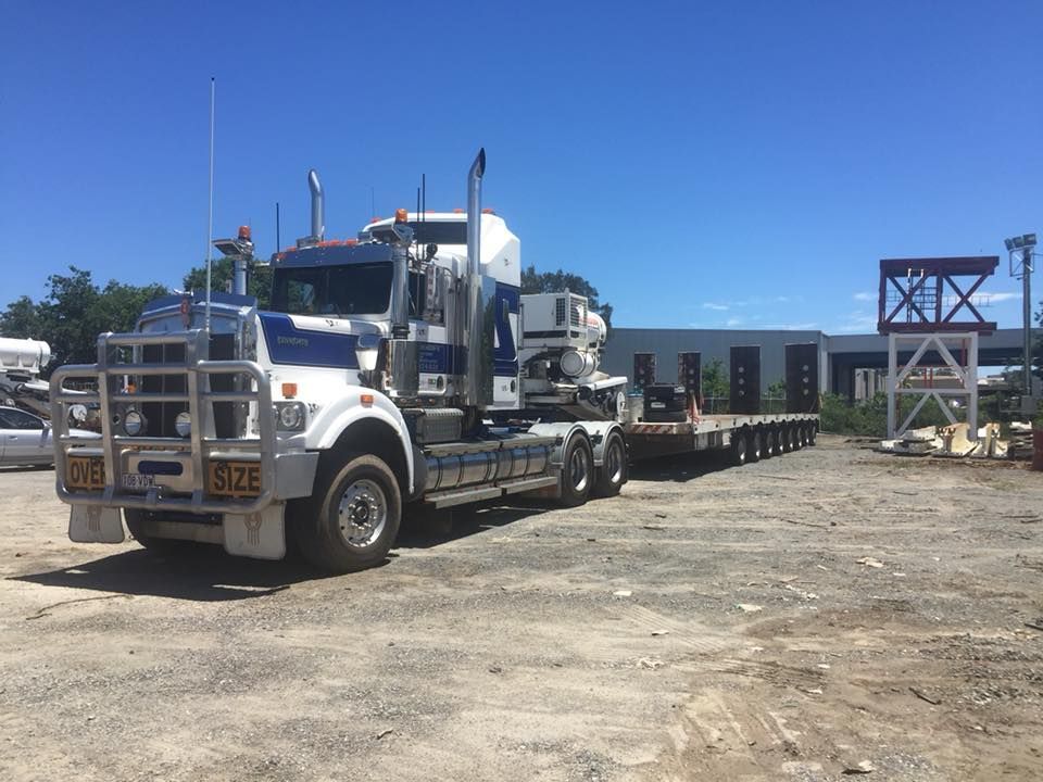 White and Blue Semi-truck With a Flatbed Trailer Parked on Gravel — Supertilt Brisbane In Molendinar, QLD