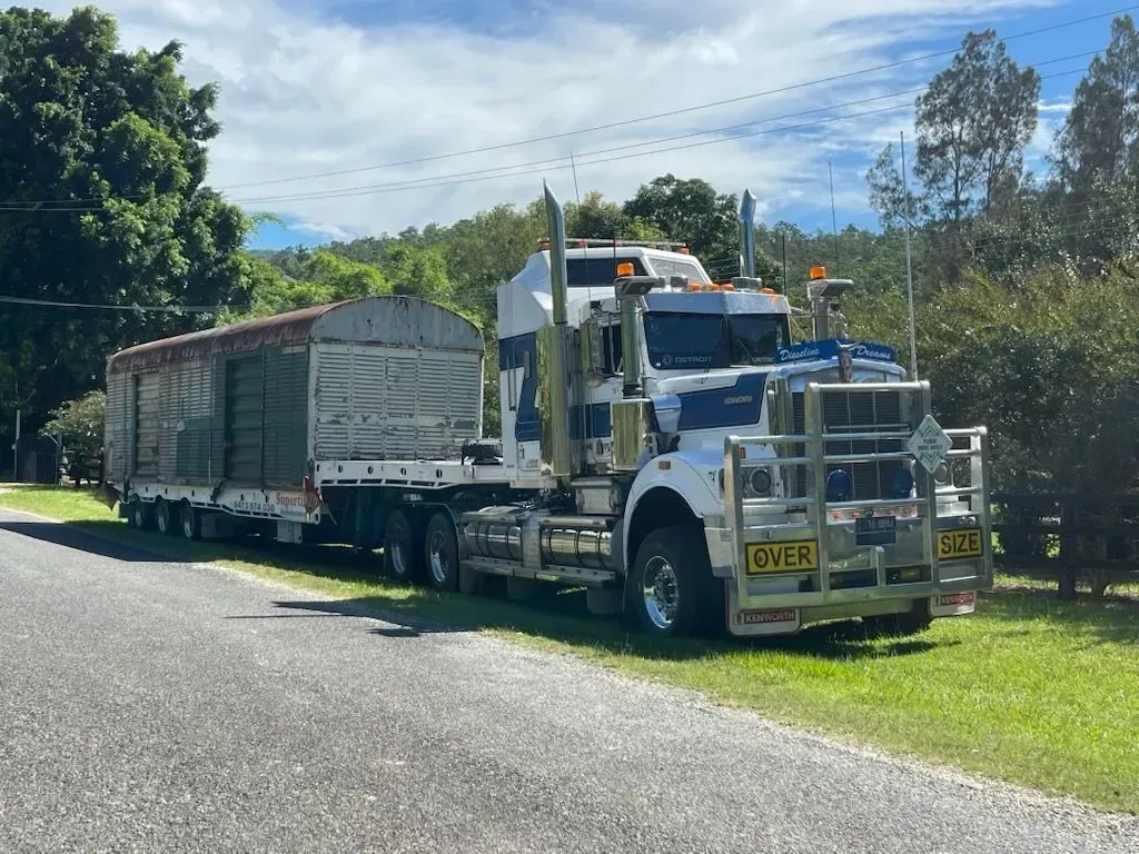 Semi-truck with trailer parked on the side of a rural road, trees in the background — Supertilt Brisbane In Bracken Ridge, QLD