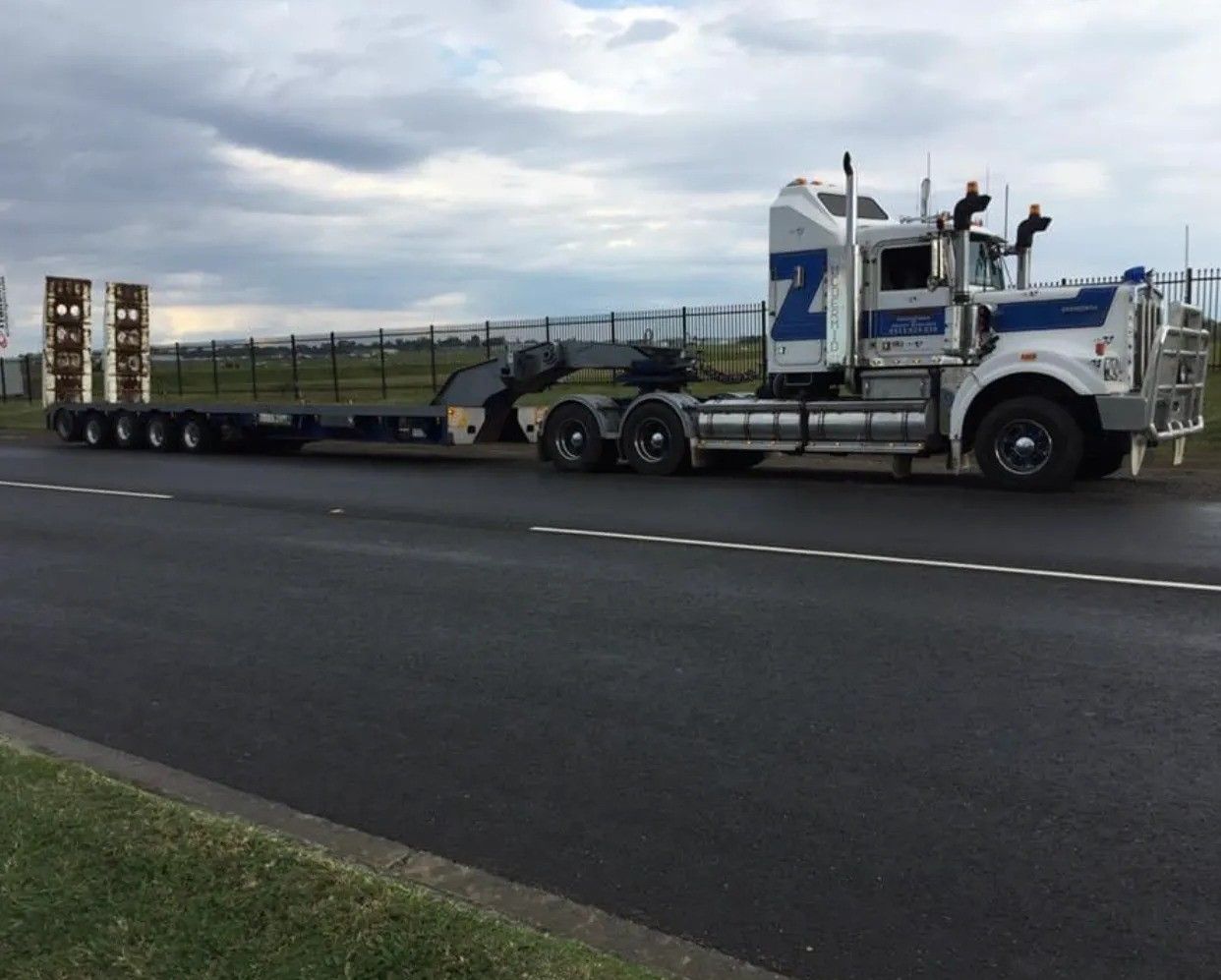 Large White and Blue Semi-truck With an Empty Flatbed Trailer — Supertilt Brisbane In Staplyton, QLD