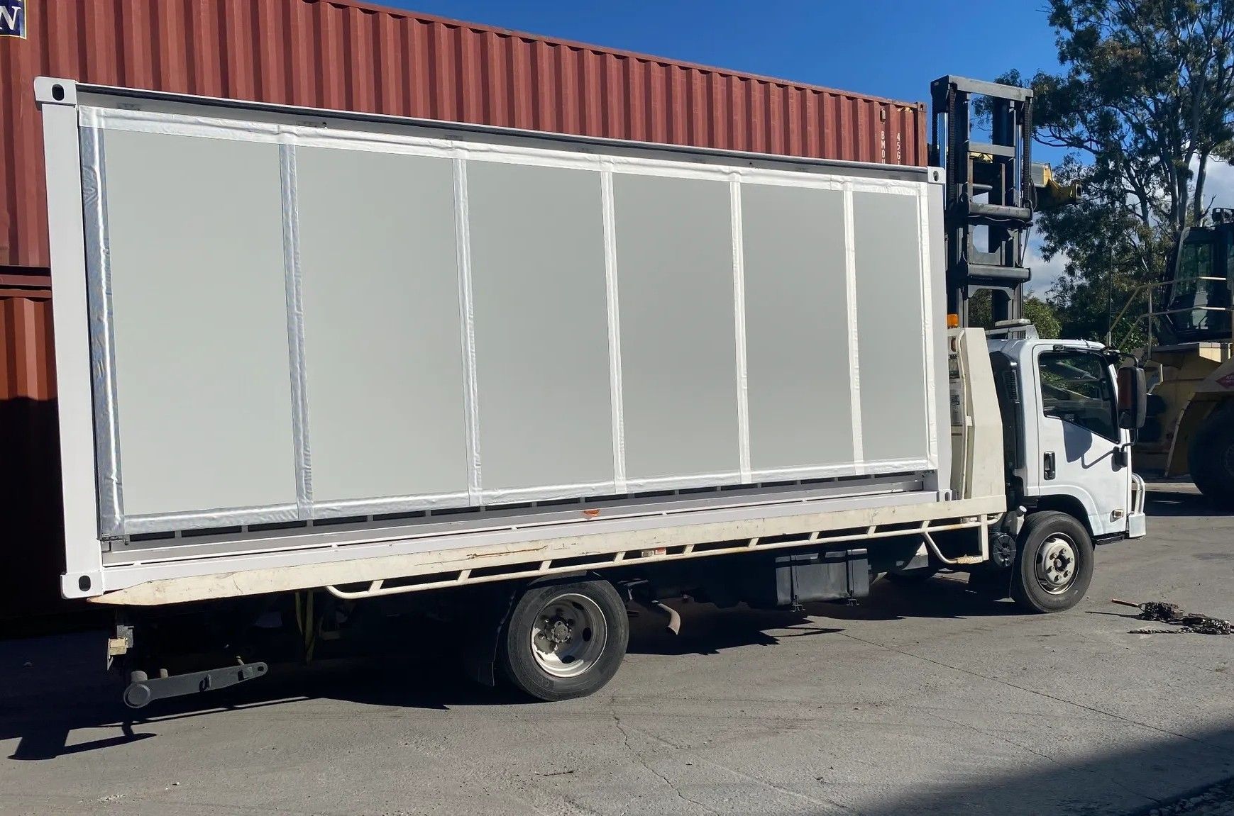 White Truck Carrying a Large, Grey Refrigerated Container — Supertilt Brisbane In Bracken Ridge, QLD