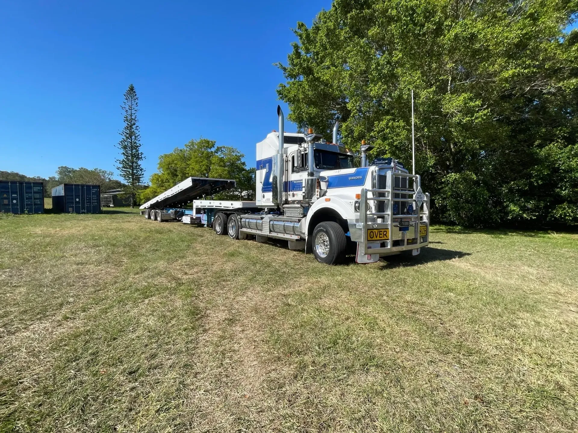 White and Blue Semi-truck With a Flatbed Trailer on Grass — Supertilt Brisbane In Bracken Ridge, QLD