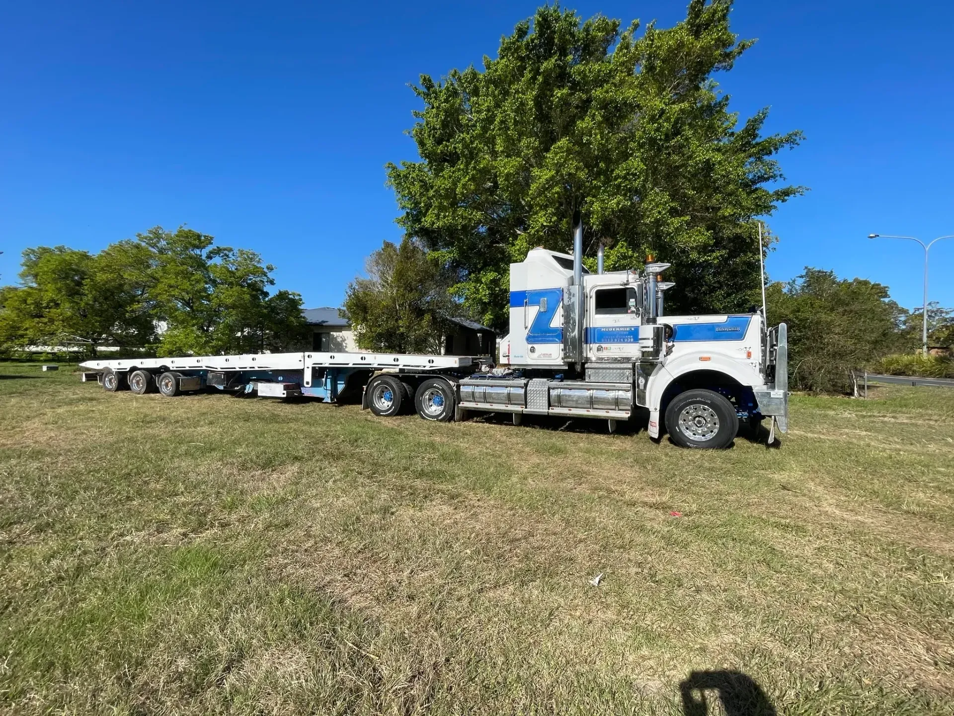 A Weathered Blue and White Semi-truck With a Long Trailer — Supertilt Brisbane In Bracken Ridge, QLD
