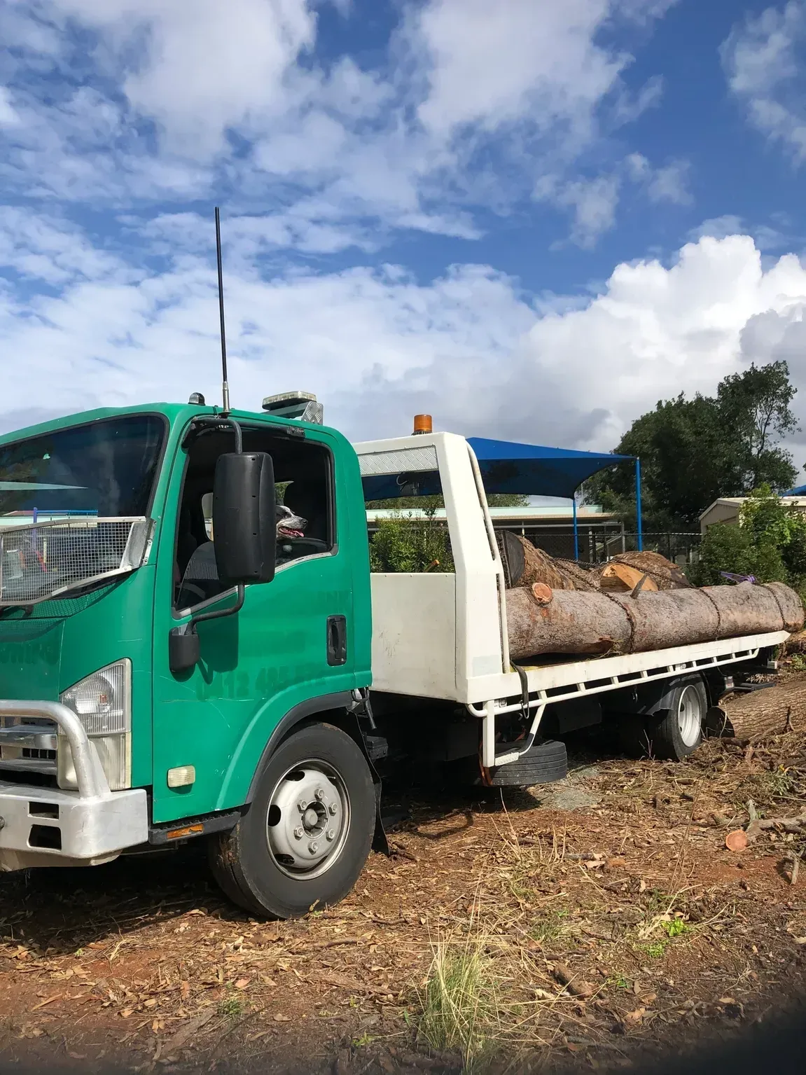Green Flatbed Truck Loaded With Logs — Supertilt Brisbane In Yatala, QLD