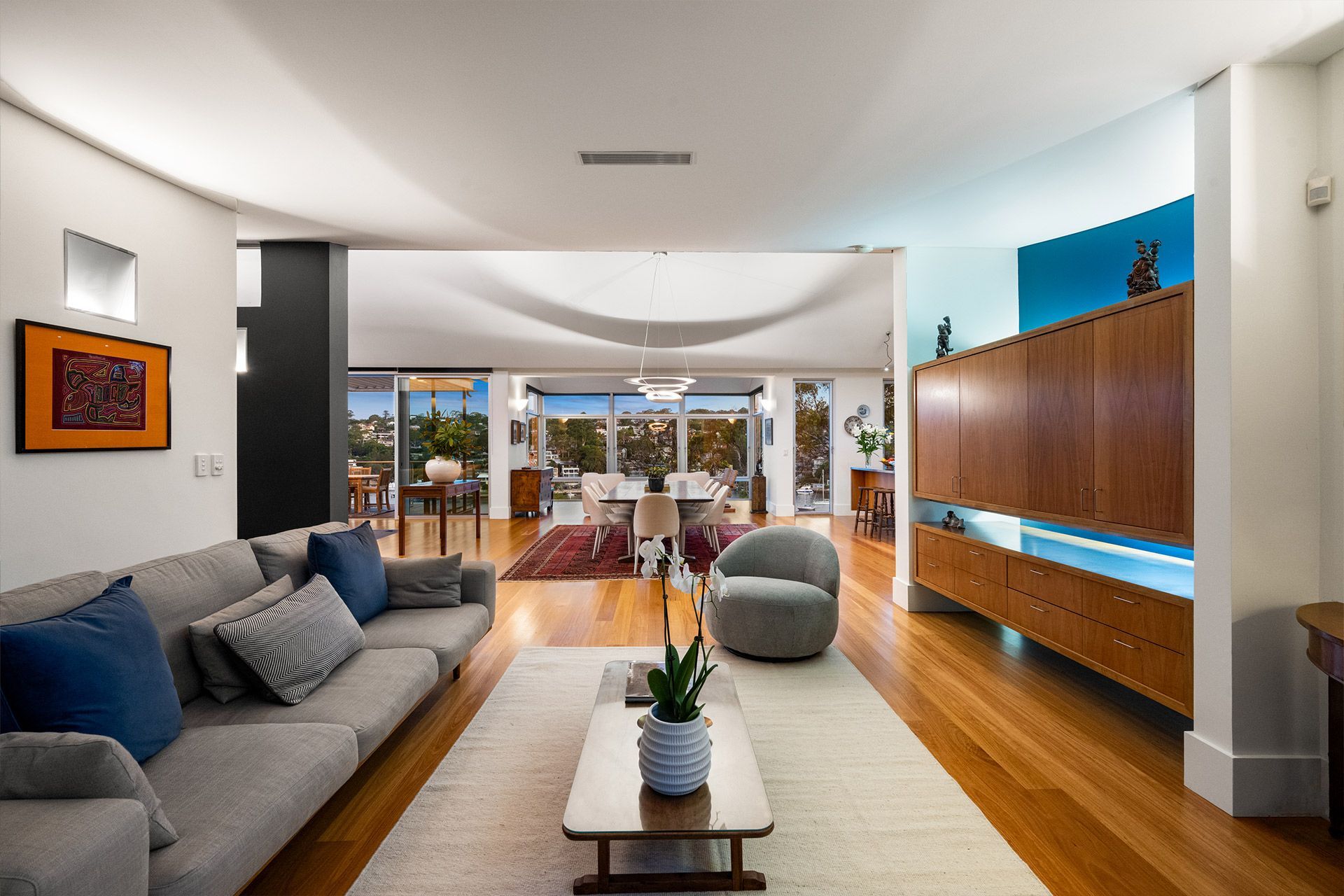 A living room with a couch , chair and coffee table.