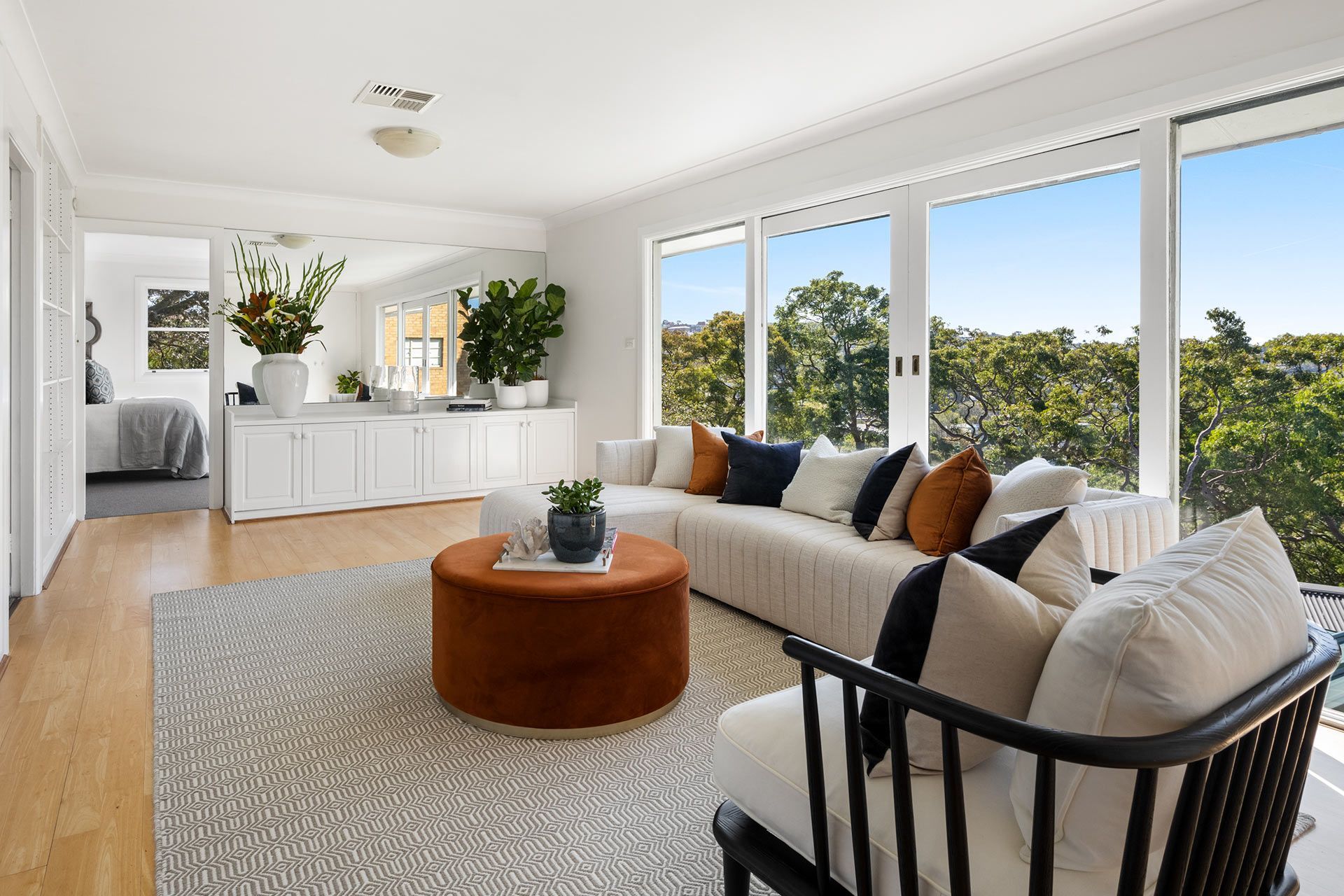 A living room with a couch , chair , coffee table and lots of windows. Balmoral