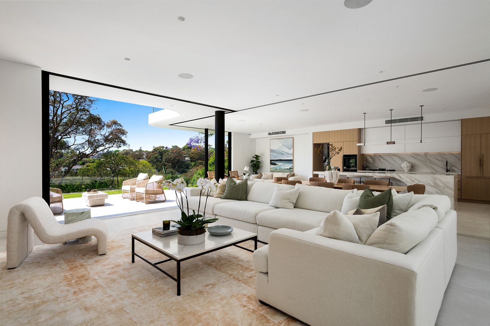 A living room with white couches and a coffee table