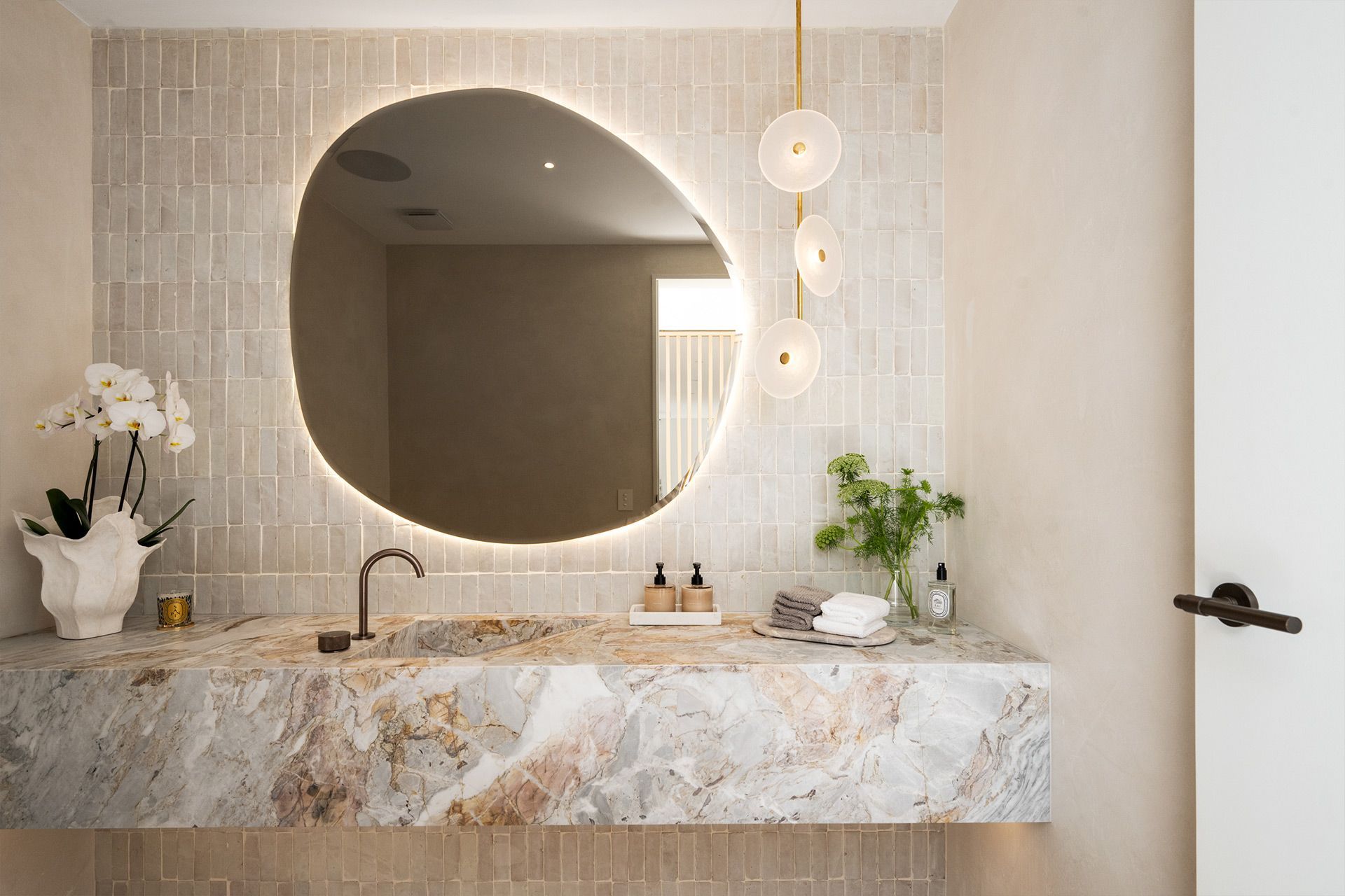 A bathroom with a sink and a large mirror. Balmoral