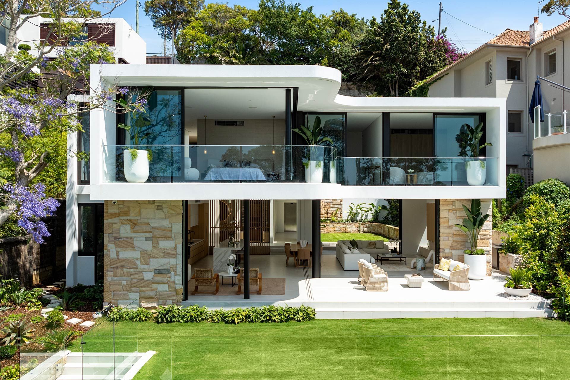 A modern house with a large lawn in front of it.