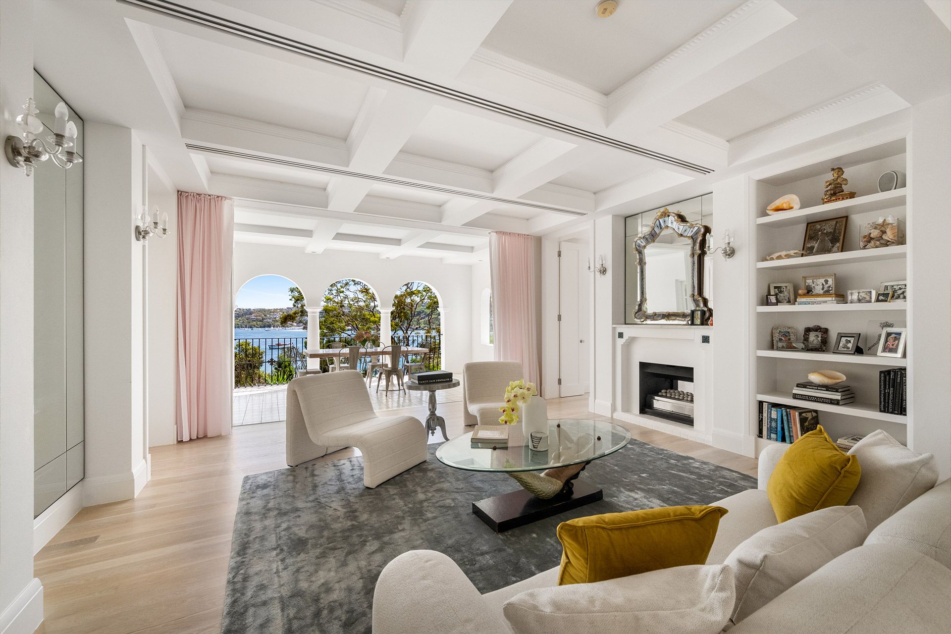 A living room with a couch , chairs , a coffee table and a fireplace.