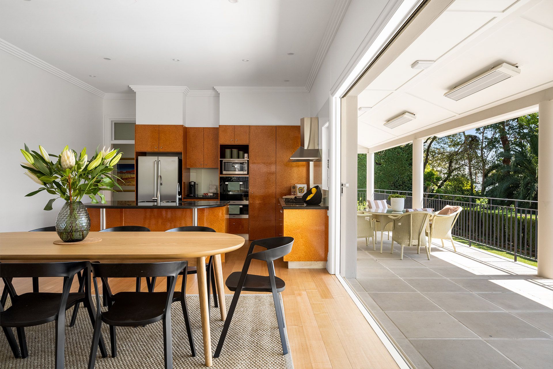 A kitchen and dining room in a house with a table and chairs.