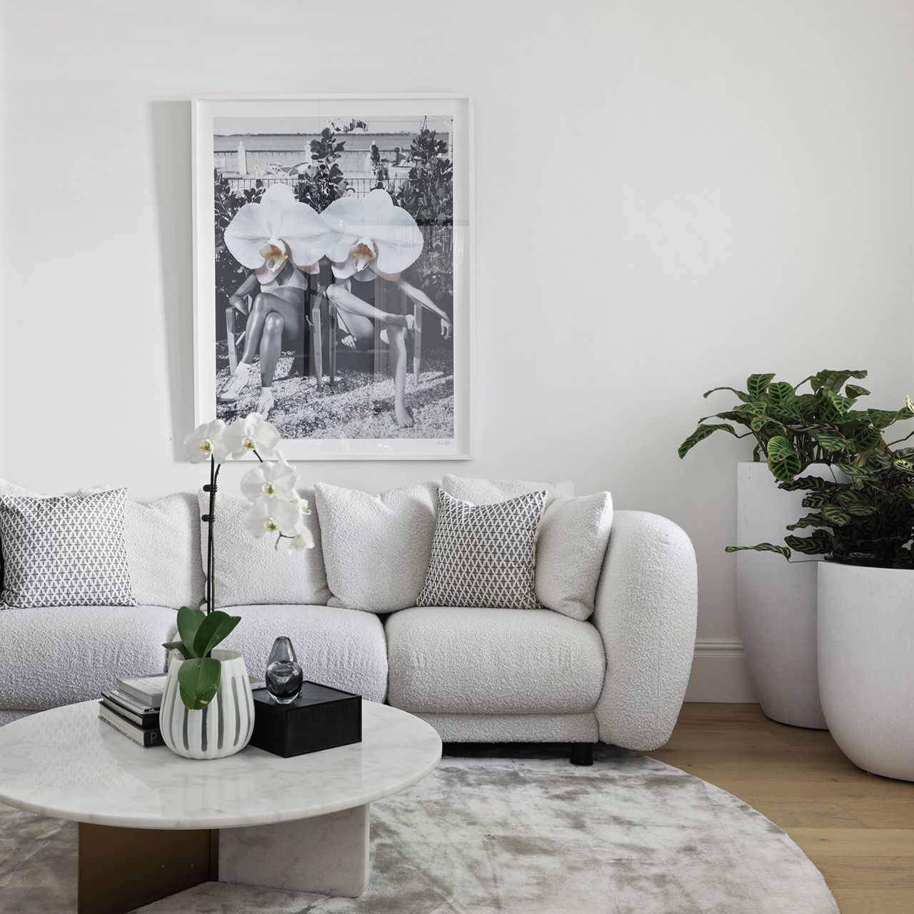 A living room with a white couch and a picture on the wall. Mosman
