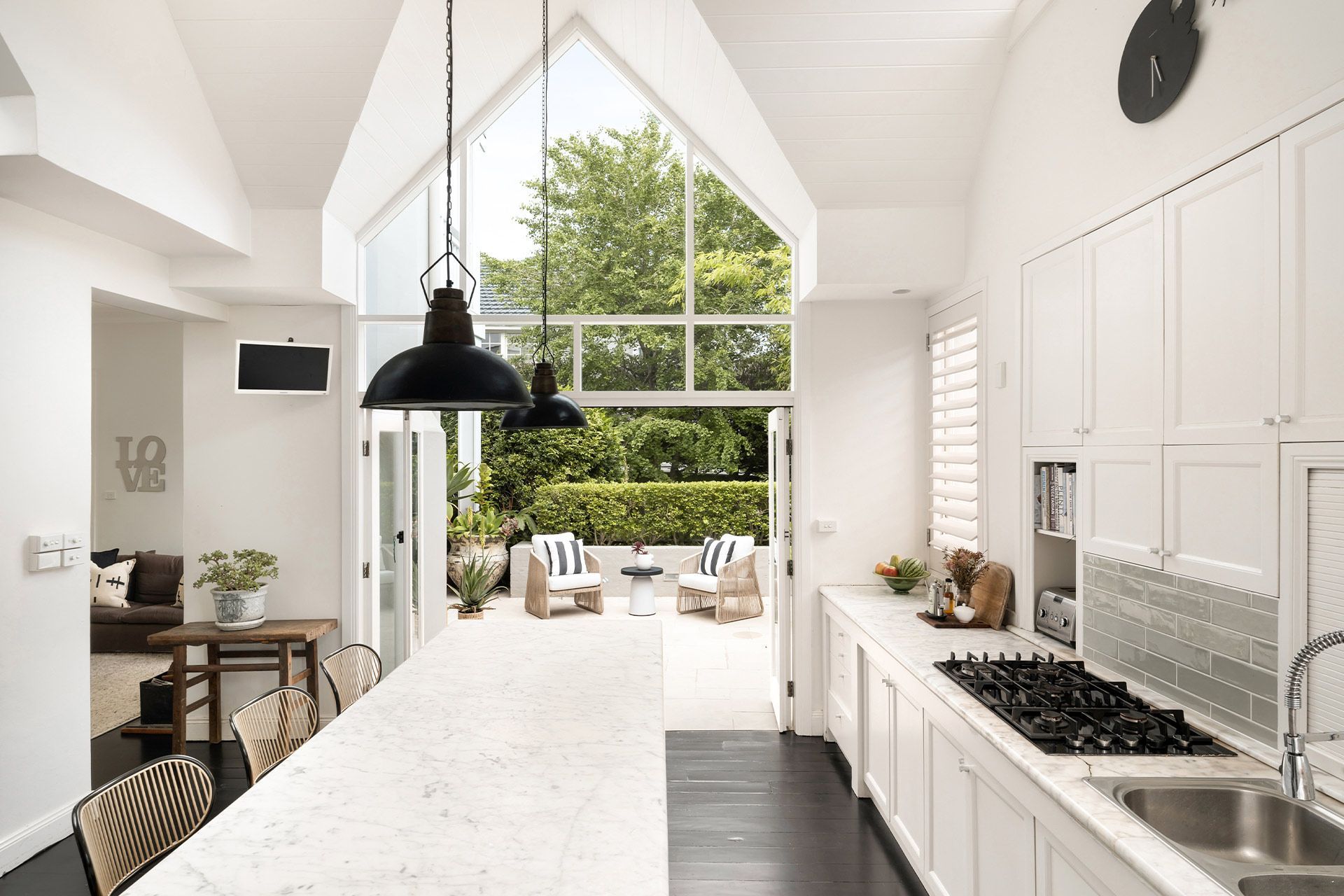 A kitchen with a large island and a clock on the wall. Balmoral, Mosman.