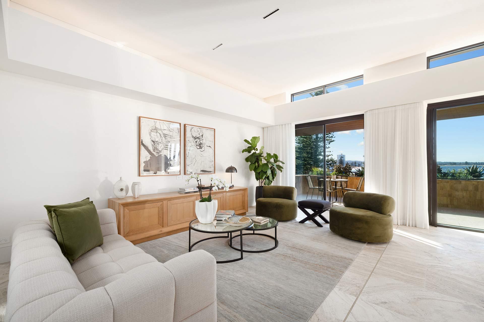 A living room with a couch , chairs , and a coffee table.