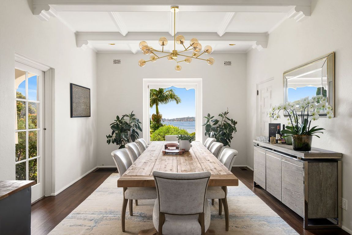 A dining room with a long wooden table and chairs. Balmoral.