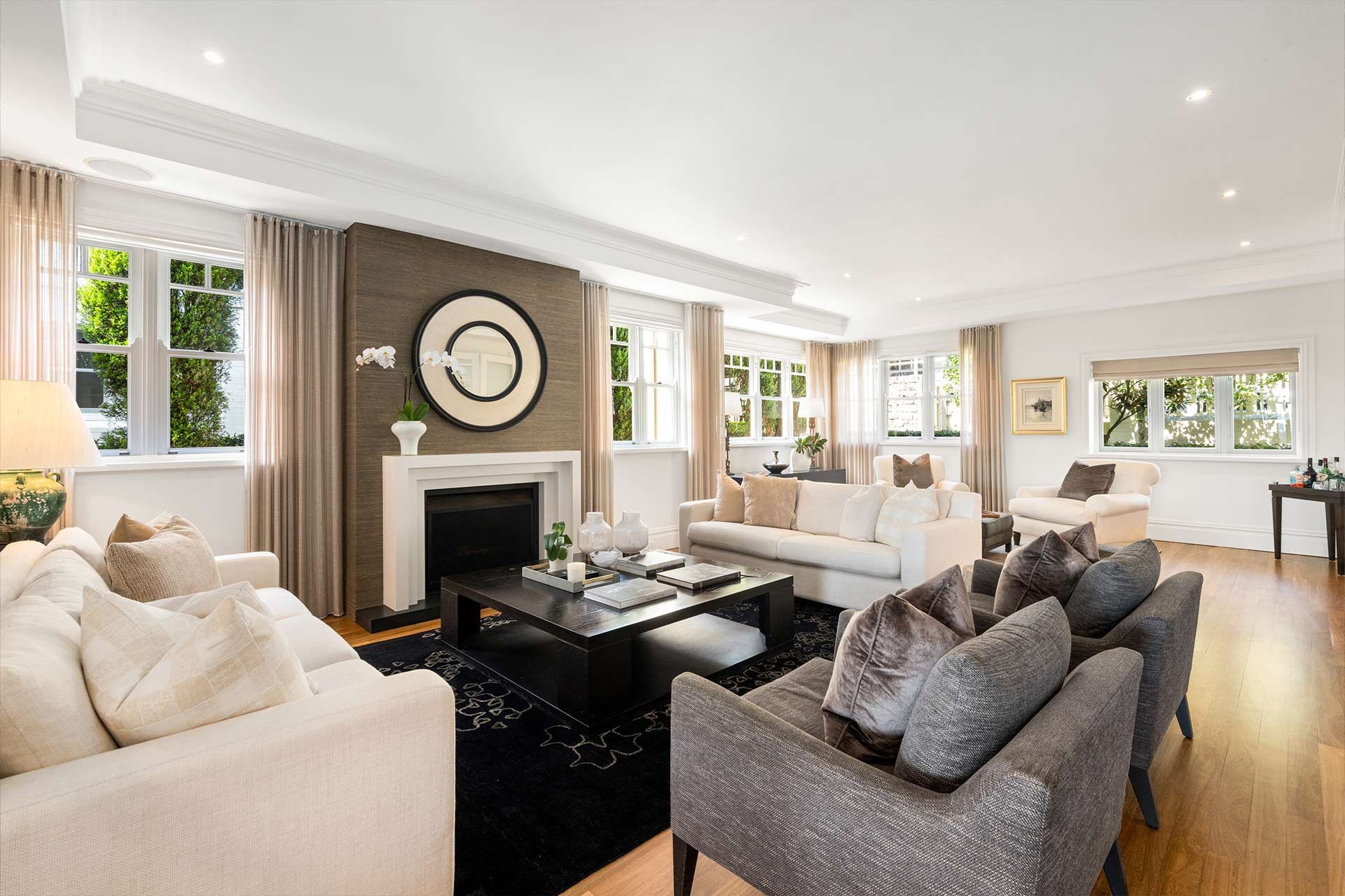 A living room filled with furniture and a fireplace. Cremorne
