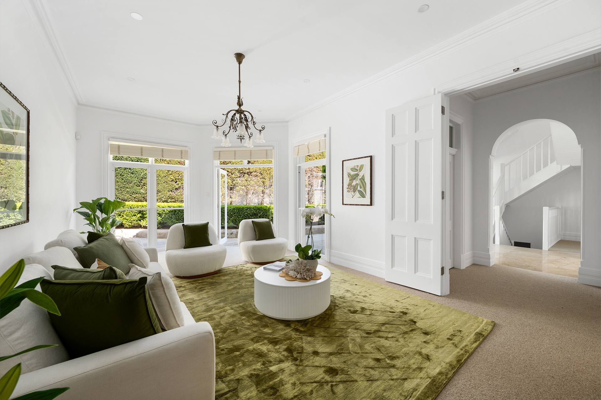A living room filled with furniture and a green rug.