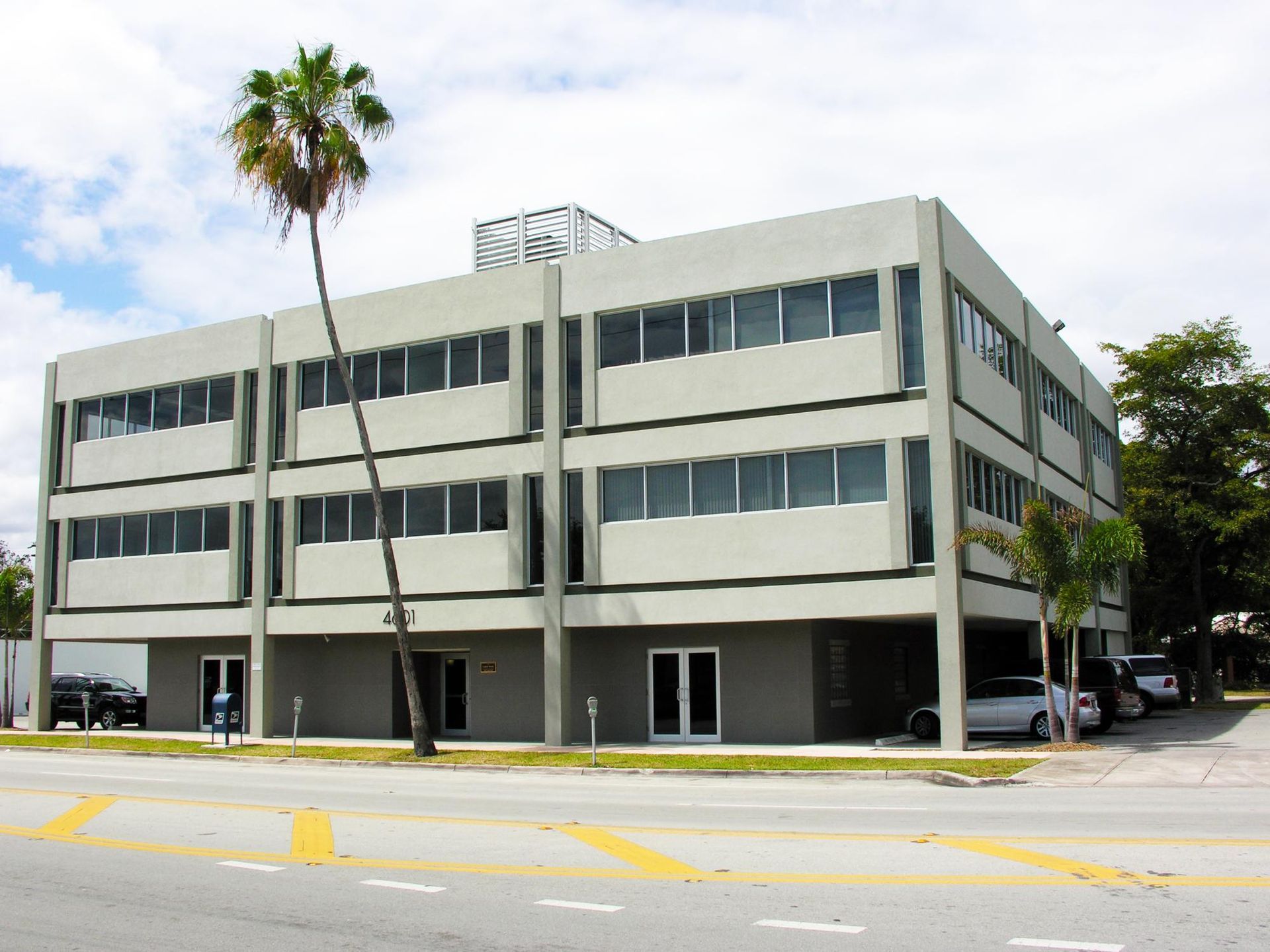 A large building with a palm tree in front of it