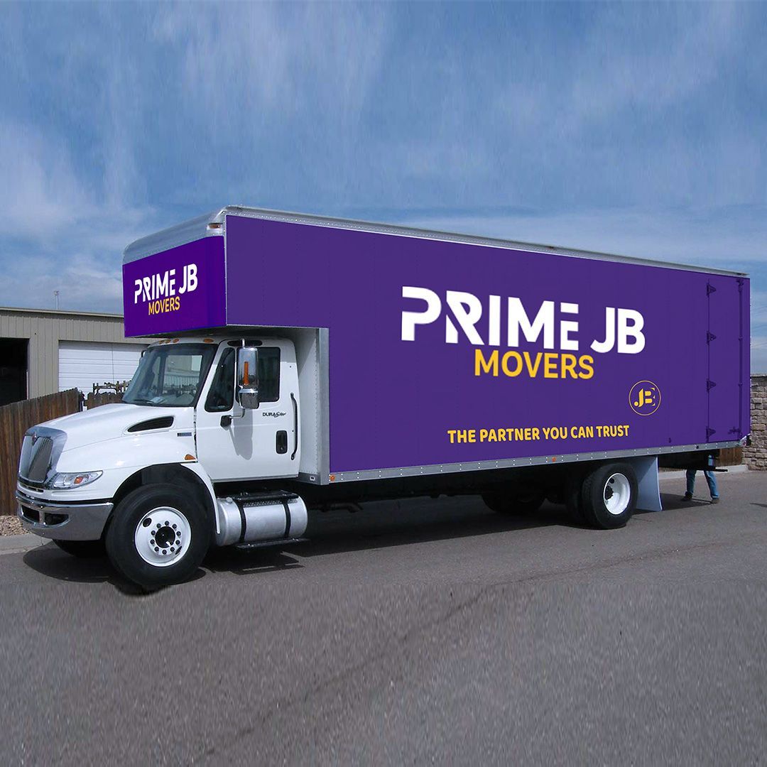 White Prime JB Movers truck with purple signage parked on asphalt.