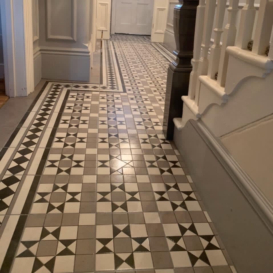 Long tiled hallway using Victorian tiles with staircase on right
